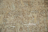 The distressed texture of a vintage Tabriz carpet highlights the forest design and exposed foundation.