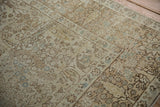 Detailed view of the worn, low pile and forest design motifs on a vintage Tabriz carpet.