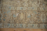 Time-softened texture on a vintage Tabriz rug revealing the brown and dusty blue forest motif.