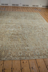 Low angle view of a distressed Tabriz carpet, emphasizing its length and time-softened neutral colors.