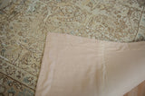 Full linen backing on the reverse of a distressed Tabriz carpet for stabilization.