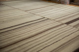 Patchwork panels with varying banded striations in coffee brown and antique ivory Kilim.