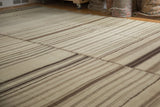 Close-up of vintage Turkish Kilim patchwork, showing hemp grain sack panels with brown and greige striations.