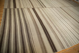 Close-up of vintage Turkish Kilim with chocolate brown and ivory vertical stripes, subtle mend.