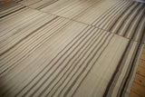 Vintage Turkish Kilim featuring hand woven patchwork seams and banded brown striations.