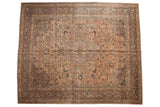 Distressed vintage Kashan carpet featuring concentric medallion, faded peach field, and blue floral motifs.