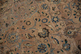 Faded scrolling floral motifs with visible knot wear on a distressed vintage Kashan rug.