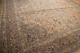 Distressed vintage Kashan carpet detail: worn pile, scrolling islimis, and multi-tiered palmettes.