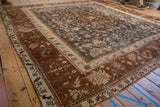 Vintage Oushak square rug: charcoal field, delicate vinery, starburst florals, wide chestnut border.