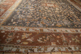 Vintage Oushak rug corner detail: charcoal field vinery, ivory band, wide chestnut main border.