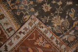 Vintage Oushak rug corner displaying charcoal vinery, wide ivory border, and woven back.