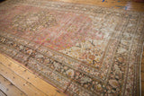 Storied wear on the distressed vintage Doroksh carpet's dusty raspberry field and charcoal border.