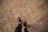 Distressed vintage Mahal carpet showing worn allover floral pattern and muted pastel hues.