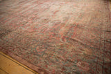 Faded floral sprays on the patinaed surface of a vintage distressed Mahal carpet.