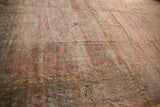 Distressed Mahal carpet's faded cochineal red and dusty teal floral motifs with visible wear.