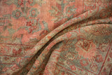 Worn pile texture of a distressed Mahal rug, with floral vinery in blush and dusty teal.