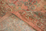 Distressed Mahal carpet detail: worn cochineal red and dusty teal floral pile revealing hand-knotted foundation.