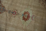 Evenly worn pile of a vintage Tabriz showing a faded floral motif in rust and muted blue tones.