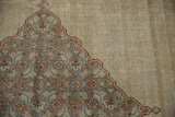 Worn pile showing faint foundation beside the medallion corner of a distressed Tabriz carpet.