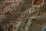 The fine, even wear on the hand-knotted pile of a vintage Tabriz, showing its pliable texture.