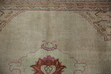 Even wear and minor speckling on the vintage Tabriz carpet's hand-knotted beige pile.