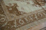 Angled view of the worn texture on the coffee brown corner spandrel and floral border.