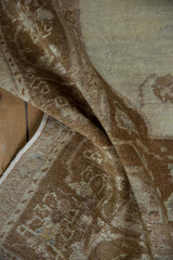 A close-up of the distressed, even wear and soft pile on a vintage Turkish Oushak rug.