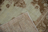 The hand-knotted back and evenly worn pile of a vintage Oushak rug.
