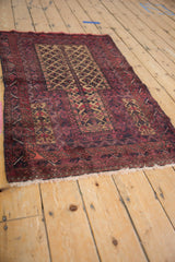 Germinating tree of life motif in camel and dark red geometric minor panels on a Belouch rug.