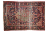 Antique Persian Farahan Sarouk rug with oversized shield medallion, navy and red floral field.