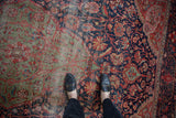 Worn antique Farahan Sarouk rug detail: navy blue and faded green floral vinery.