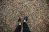 Distressed vintage Mahal carpet with allover henna motif, softened pile, and black shoes.