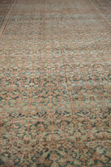 Distressed Mahal carpet close-up, showing patinaed henna plant motif in dusty teal, cherry red.