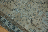 Distressed greige Karaja runner's geometric patterns with low, worn pile texture.