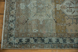 Geometric border detail on distressed Karaja runner in slate blue and greige, showing worn pile.