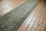 Distressed vintage Karaja runner, showing geometric medallions and muted greige-blue tones.