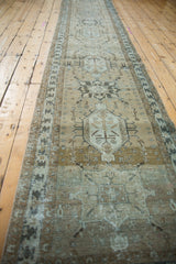 Close-up of the Karaja runner's distressed texture, faded geometric border, and greige field.
