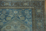 Distressed vintage Malayer runner corner, showing powder blue Herati motif and floral main border.
