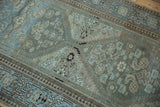 Distressed Herati stylized motifs and border details in powder blue, coffee brown.