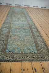 Distressed vintage Malayer runner with worn pile, fringe, and intricate blue and brown floral border.