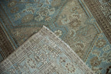 Distressed powder blue and brown pile texture with visible hand-knotted rug foundation.