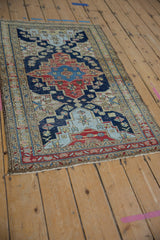 Vintage Northwest Persian rug corner detail: navy and red geometric border with secured fringed edge.