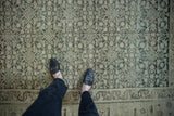 Low-pile texture and geometric Herati-inspired motif of a vintage distressed Hamadan rug.