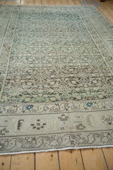 Low angle view along the vintage Hamadan carpet showing its allover texture and border design.