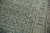 Evenly worn texture across the Herati motif and serpent-style border of a vintage Persian rug.