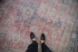 Distressed Turkish Sparta rug with faded raspberry, denim blue, and beige intricate floral vinery.