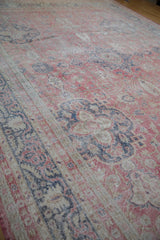 Distressed vintage Sparta carpet, showing wear to foundation, faded raspberry, blue, and beige patterns.