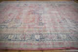 Worn texture of vintage Sparta rug with faded raspberry, denim blue, and beige vinery.