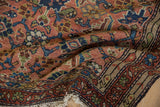 Close-up of vintage Hamadan rug corner, showing detailed Herati pattern and fringed edge.