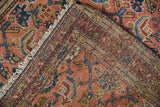 Folded vintage Hamadan rug showing dusty blush Herati pile and detailed hand-knotted foundation.